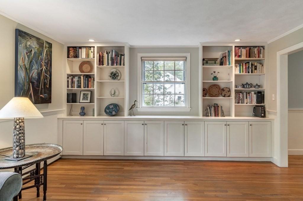 321 Hayward Mill Road Concord, MA 01742 - Photo 7 of 25 a living room with furniture a bookshelf and a window