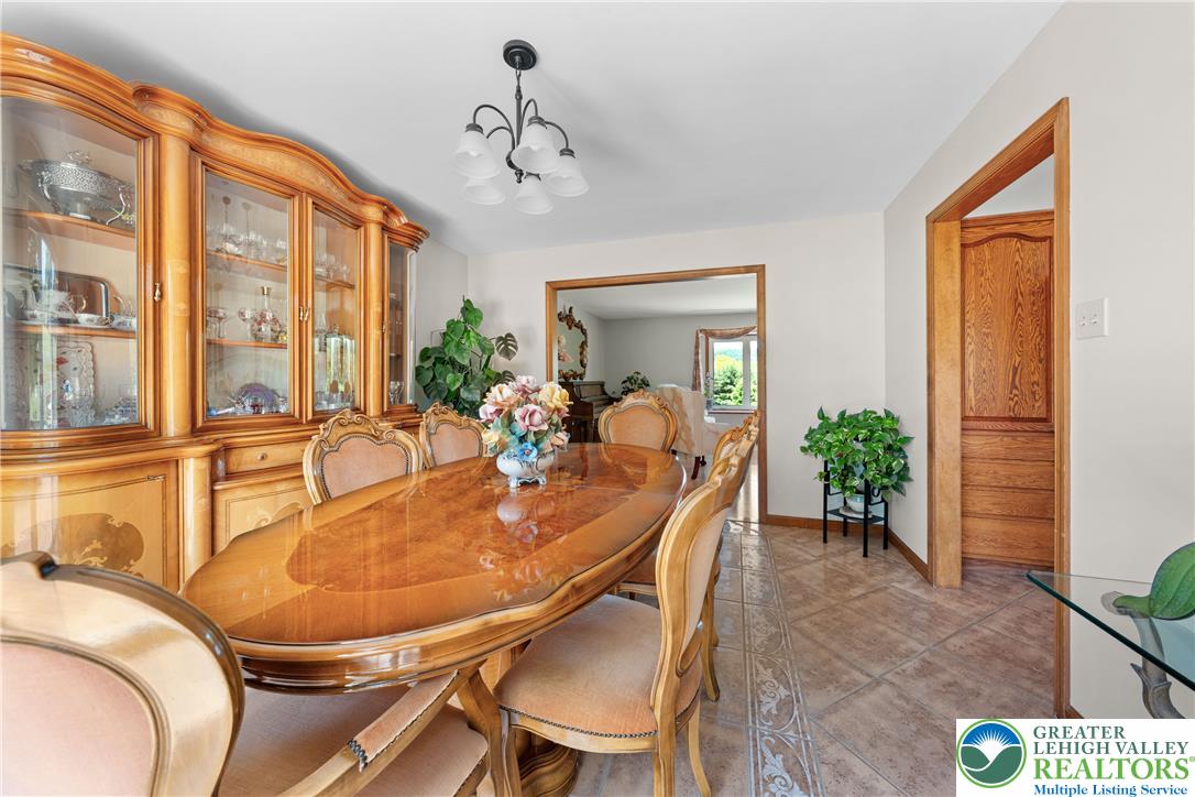 947 Tamenend Road Bath, PA 18014 - Photo 15 of 61 Ornate hardwood furniture and a classic chandelier illuminate this inviting formal dining room.