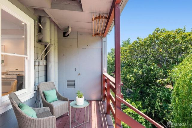 a balcony with table and chairs