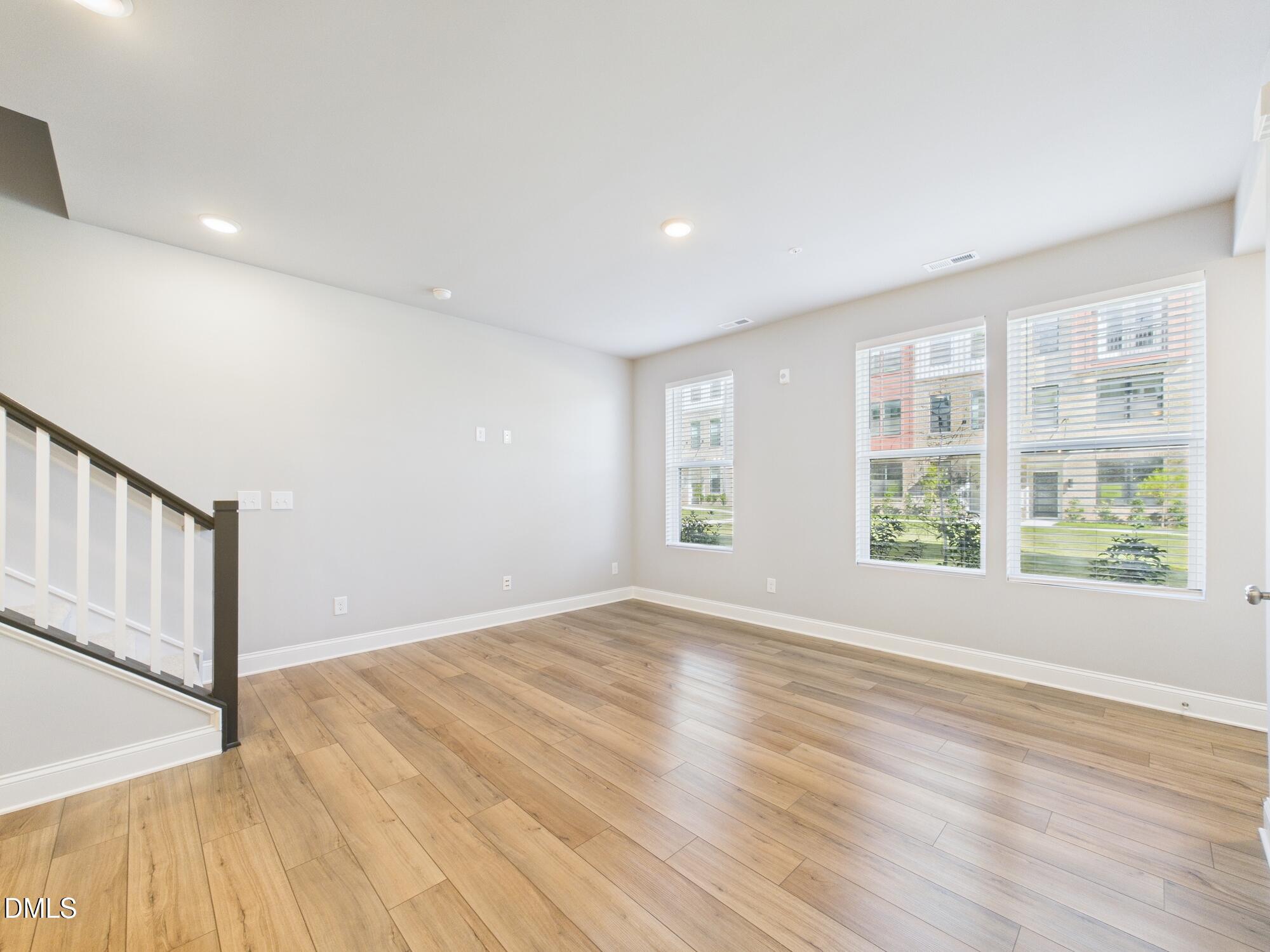 1251 Shaw View Alley, Unit 101 Raleigh, NC 27601 - Photo 11 of 47 a view of empty room with wooden floor and fan