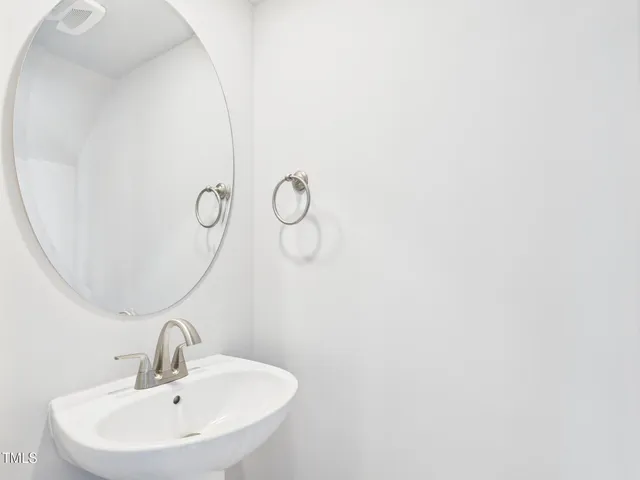 a kitchen with a sink stainless steel appliances and white cabinets