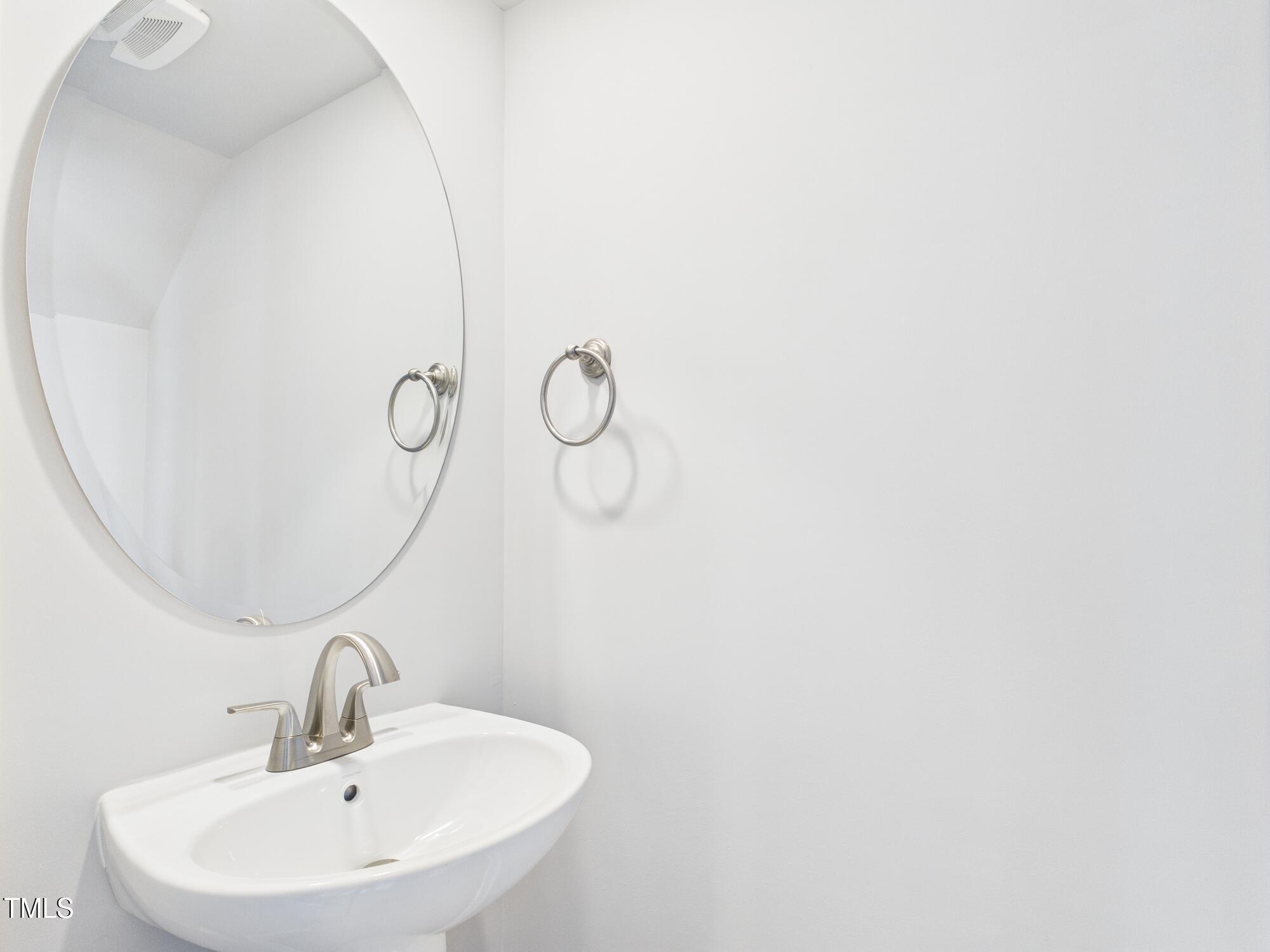 1251 Shaw View Alley, Unit 101 Raleigh, NC 27601 - Photo 12 of 47 a bathroom with a sink and mirror