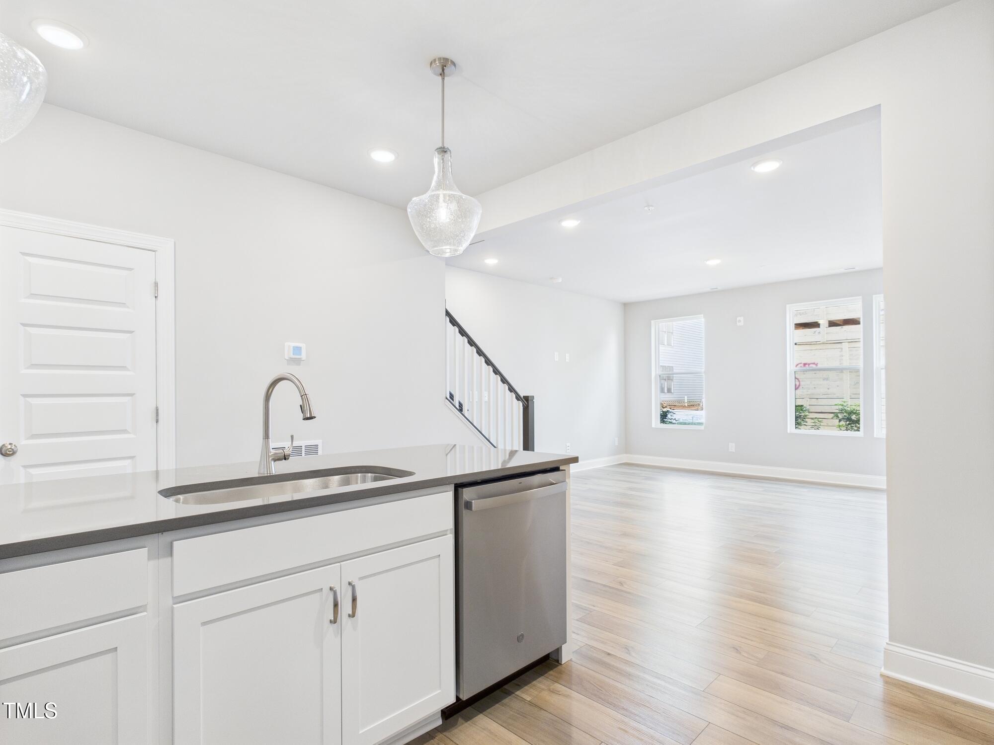 1251 Shaw View Alley, Unit 101 Raleigh, NC 27601 - Photo 15 of 47 a kitchen with cabinets and wooden floor