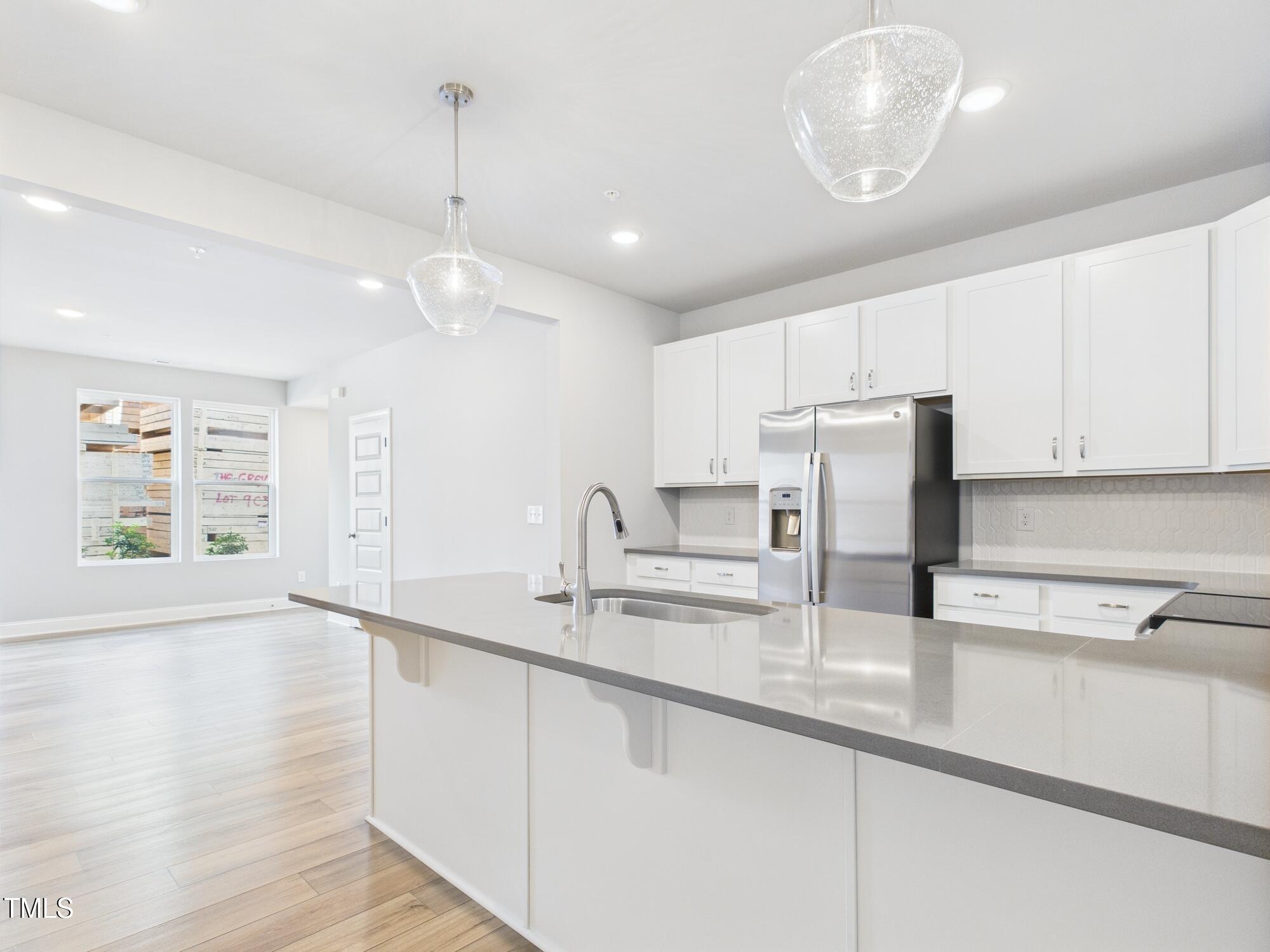 1251 Shaw View Alley, Unit 101 Raleigh, NC 27601 - Photo 16 of 47 a kitchen with stainless steel appliances granite countertop a sink a stove and a wooden floors