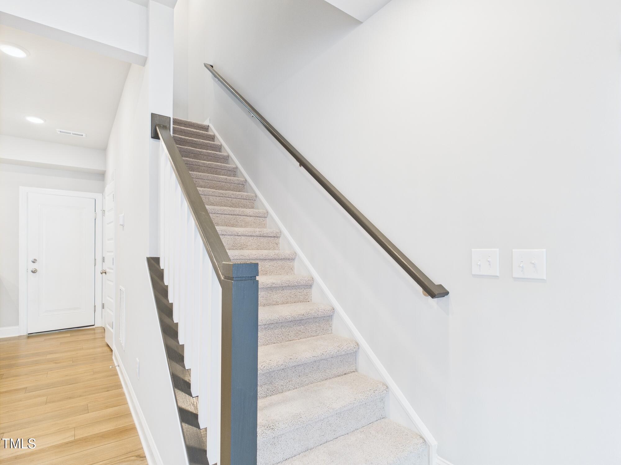 1251 Shaw View Alley, Unit 101 Raleigh, NC 27601 - Photo 17 of 47 a view of staircase with wooden floor and stairs