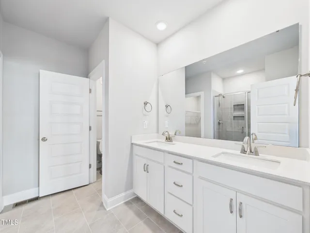 a bathroom with a glass shower door