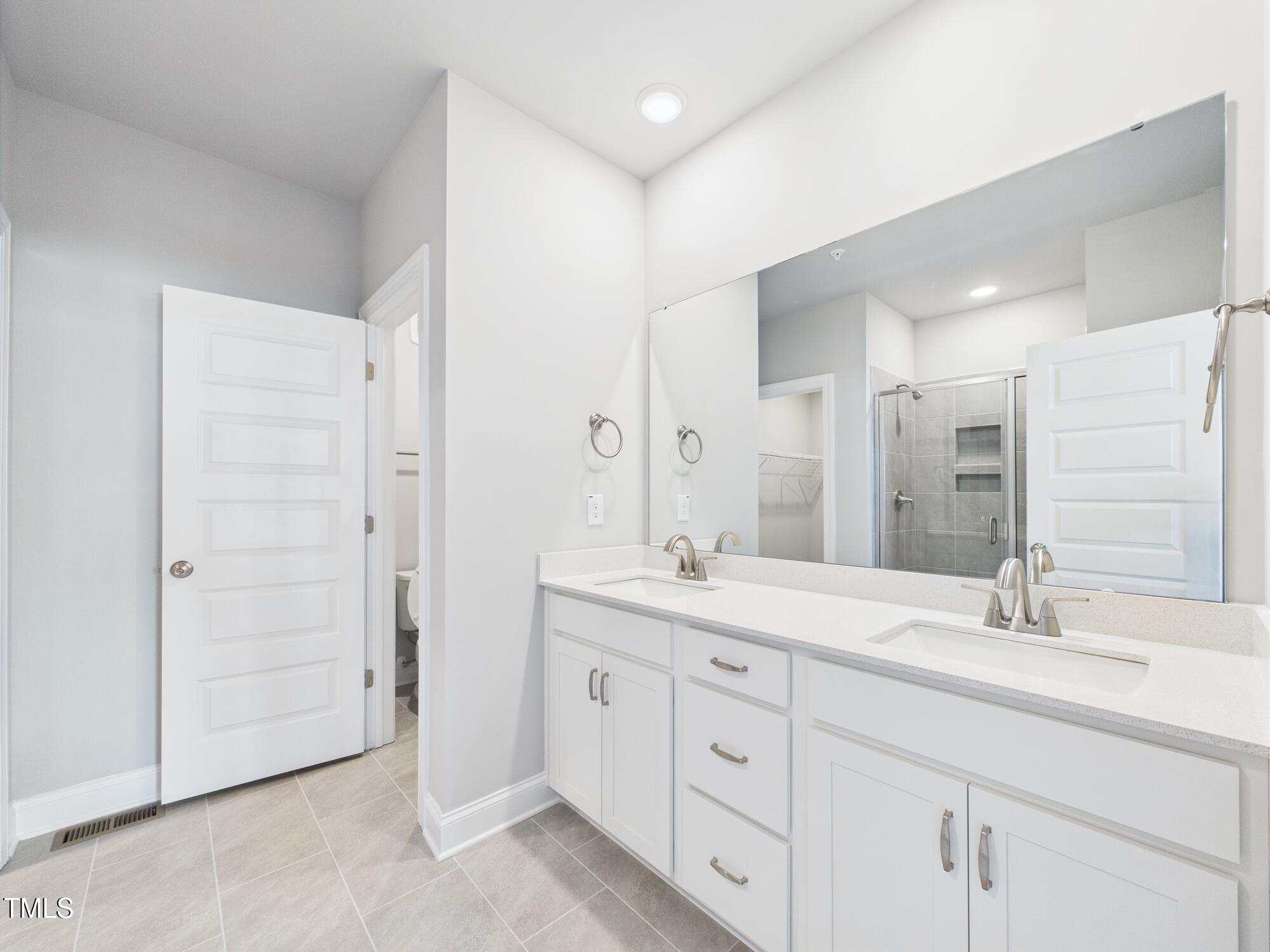 1251 Shaw View Alley, Unit 101 Raleigh, NC 27601 - Photo 25 of 47 a bathroom with a granite countertop sink mirror and double