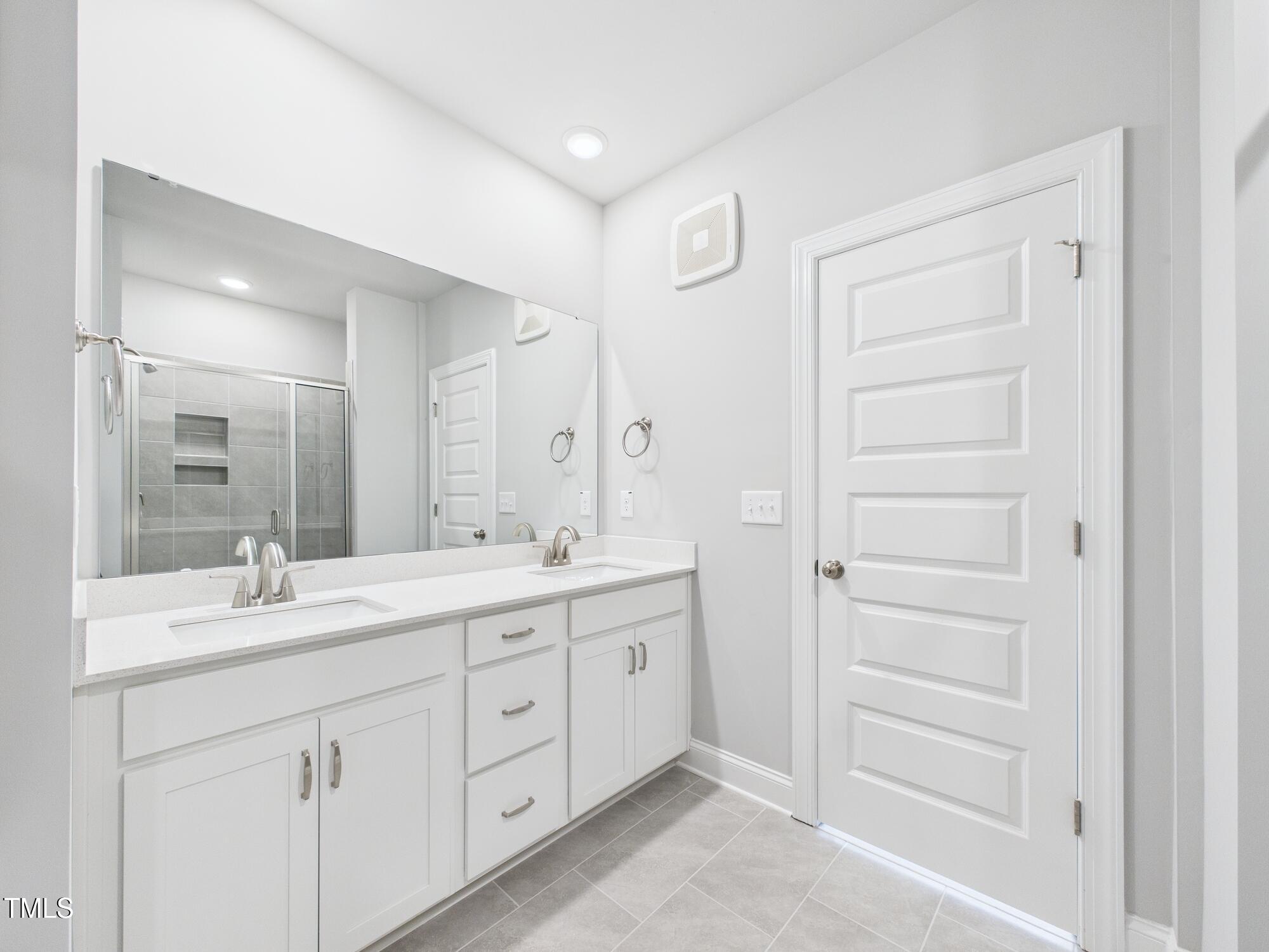 1251 Shaw View Alley, Unit 101 Raleigh, NC 27601 - Photo 26 of 47 a bathroom with a double vanity sink and mirror