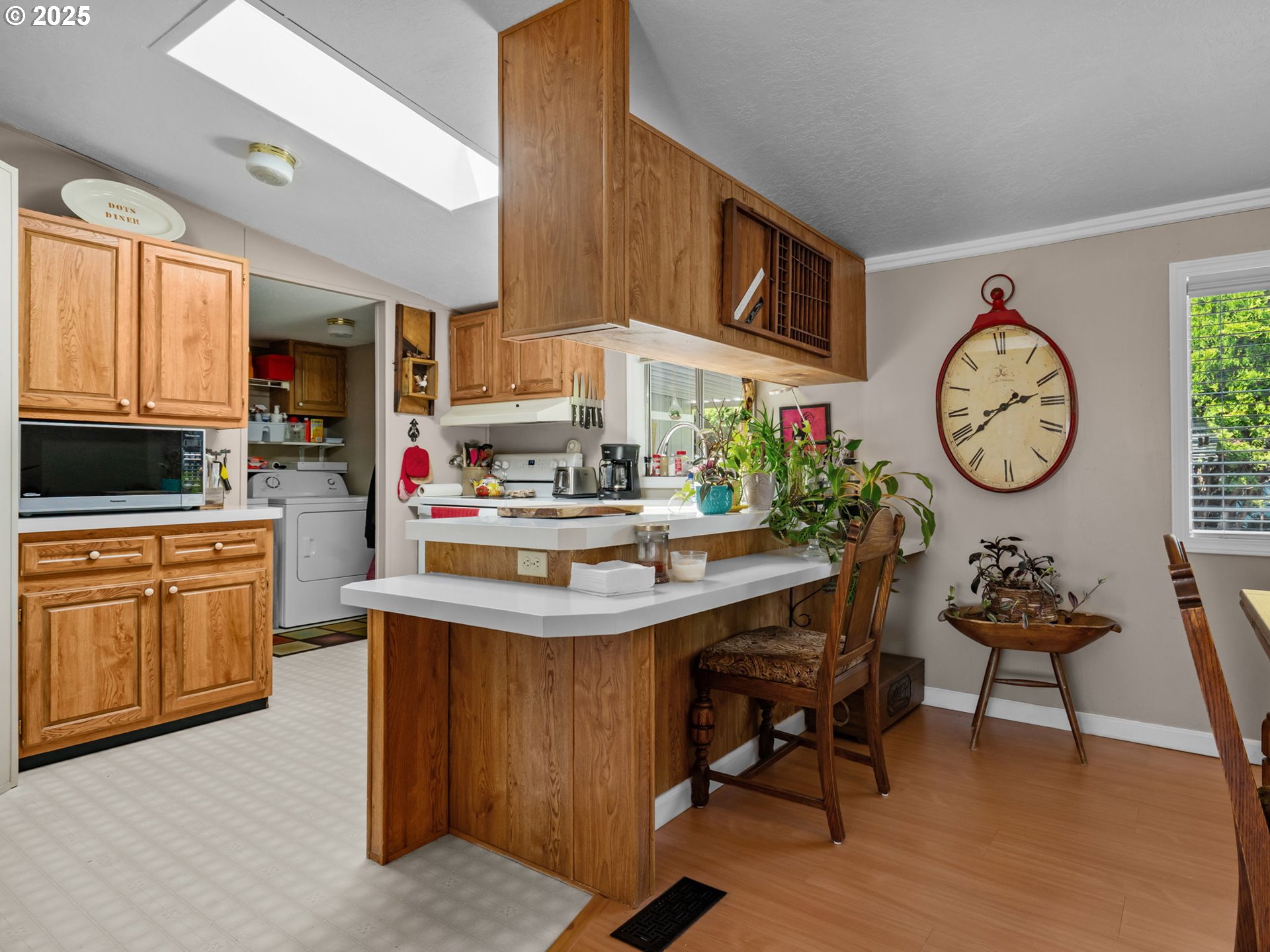 4355 Bren Loop Northeast Salem, OR 97305 - Photo 12 of 44 a kitchen with a cabinets a stove and a clock on the wall
