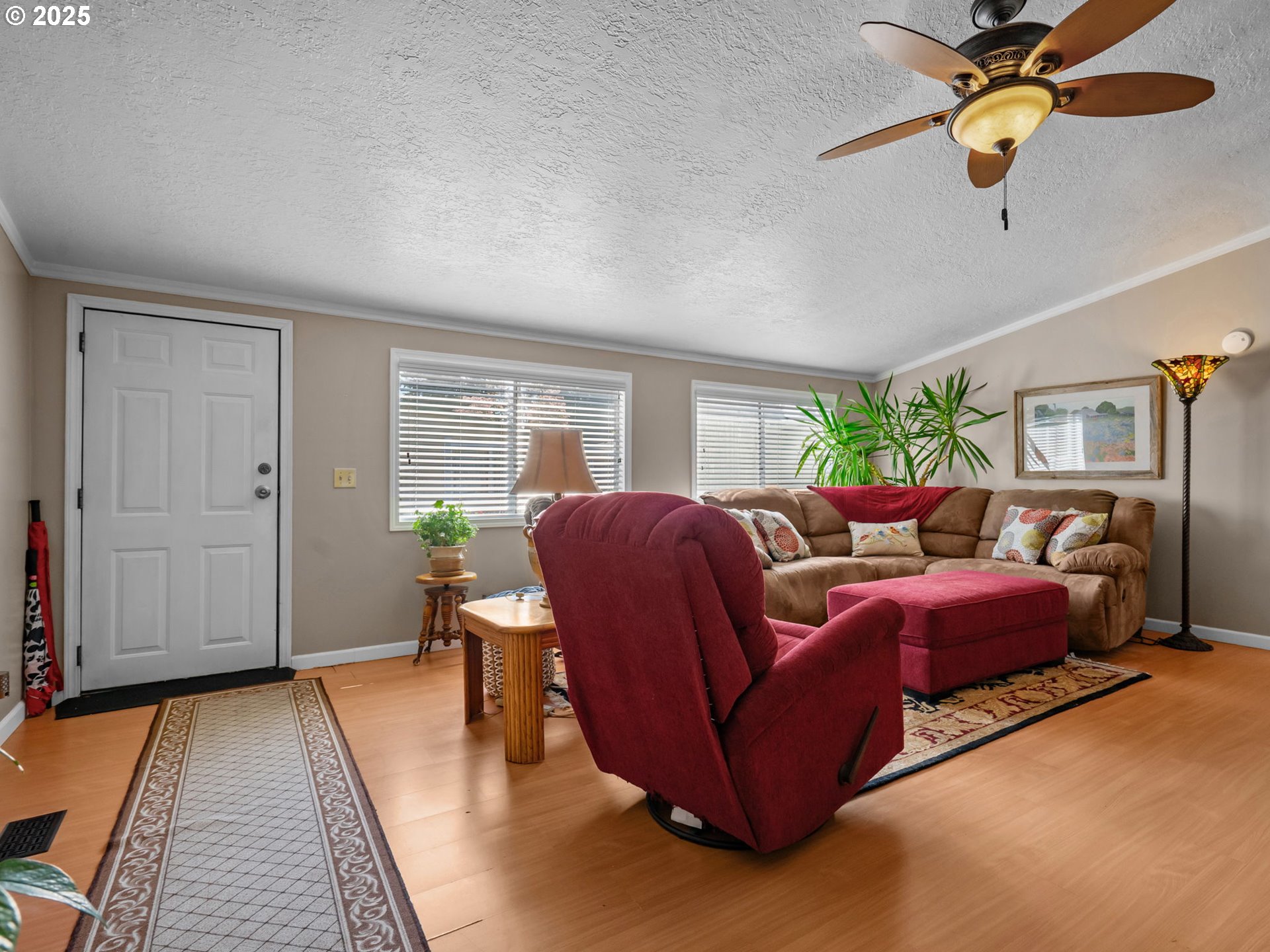 4355 Bren Loop Northeast Salem, OR 97305 - Photo 4 of 44 a living room with furniture ceiling fan and a rug