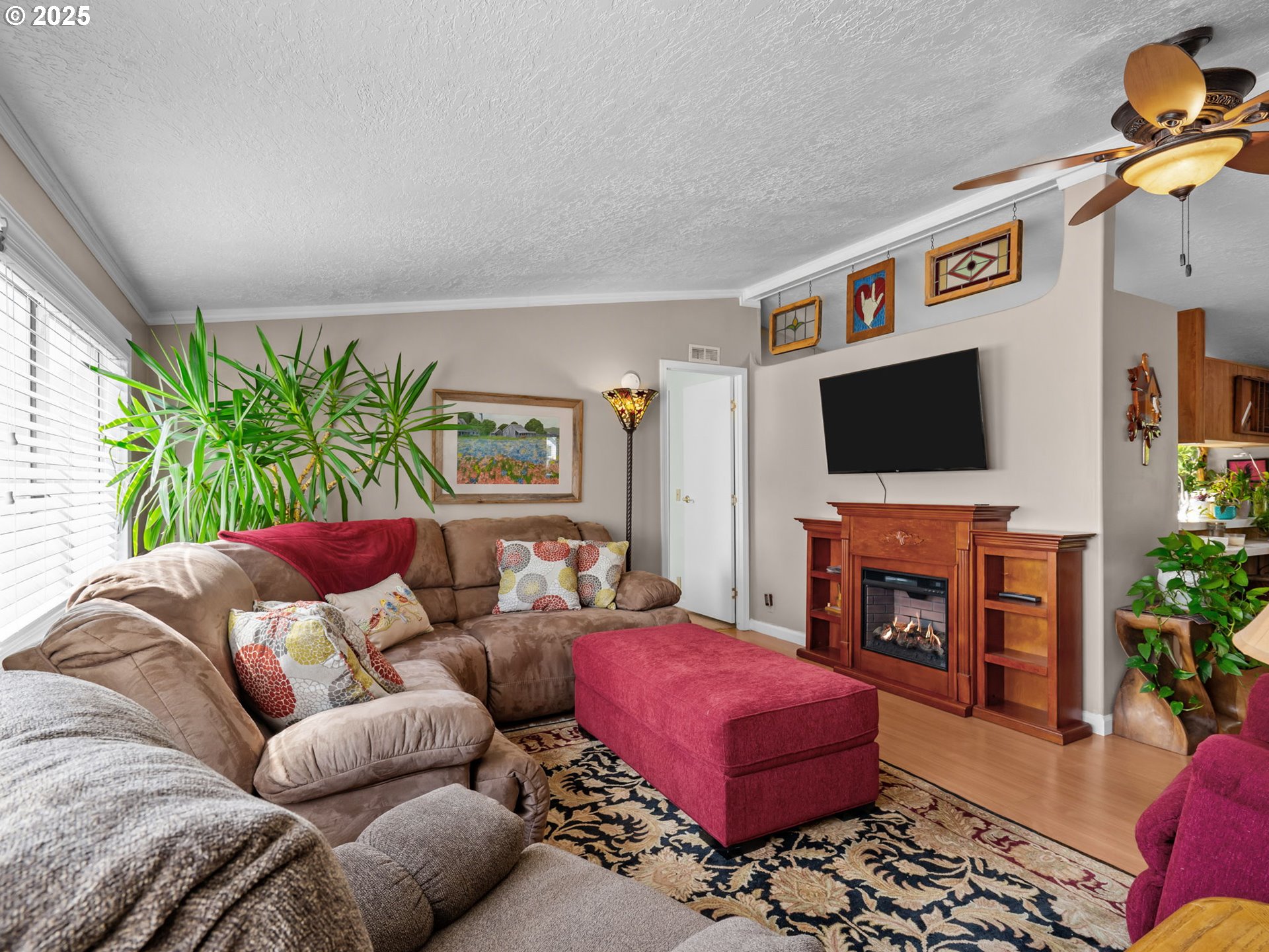 4355 Bren Loop Northeast Salem, OR 97305 - Photo 7 of 44 a living room with furniture a flat screen tv and a fireplace