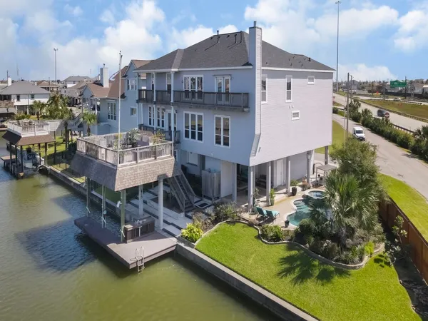 a view of a house with pool and chairs