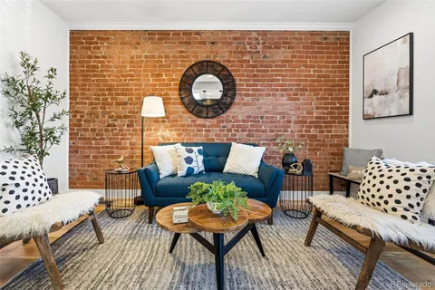a outdoor living room with furniture and wooden floor