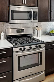 a stove top oven sitting inside of a kitchen
