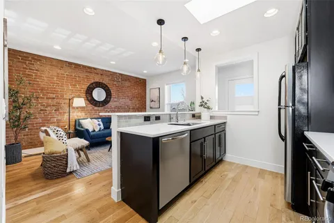 a kitchen with a sink cabinets and stainless steel appliances