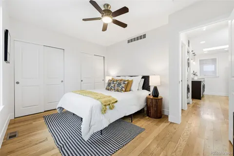 a spacious bedroom with a bed and a chandelier