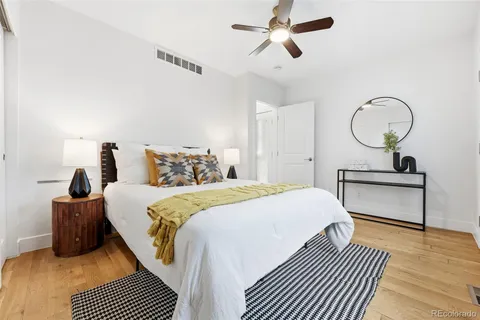 a bedroom with a bed and wooden floor