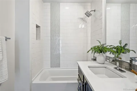 a bathroom with a tub sink and vanity