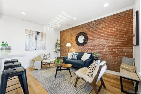 a living room with furniture and a clock