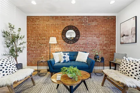 a living room with furniture a rug and a wall painting