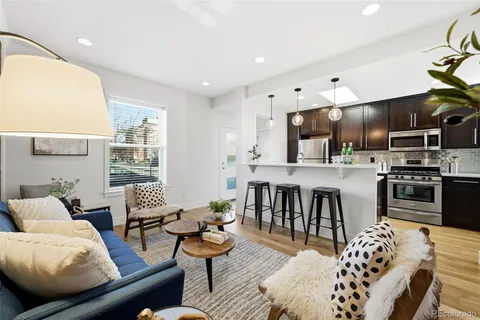 a living room with furniture kitchen and a table