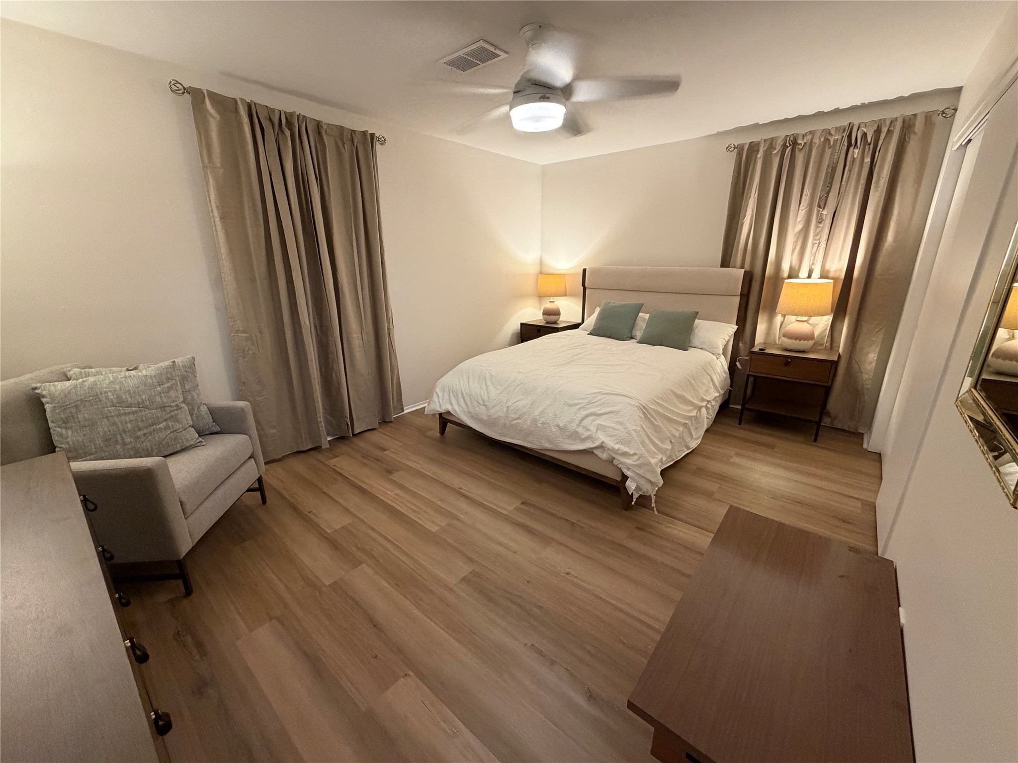 2012 Brun Street, Unit A Houston, TX 77019 - Photo 11 of 16 a bedroom with a bed couch and a large window