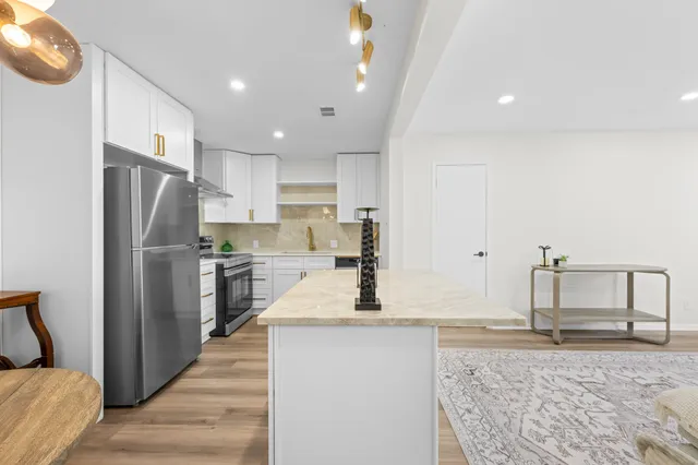 a kitchen with refrigerator cabinets and a counter top space