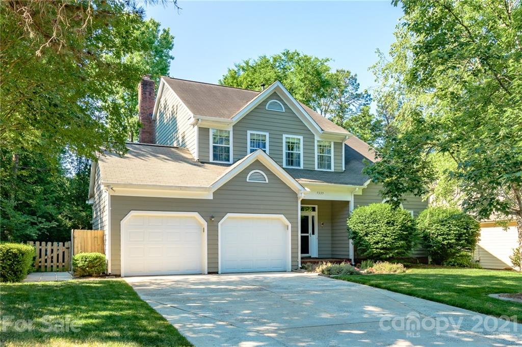 7335 Reedy Creek Road, Unit 25 Charlotte, NC 28215 - Photo 1 of 28 a front view of a house with a garden and trees