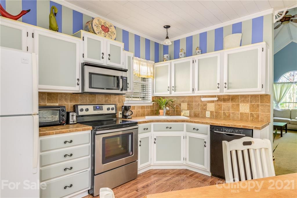 7335 Reedy Creek Road, Unit 25 Charlotte, NC 28215 - Photo 10 of 28 a kitchen with stainless steel appliances granite countertop a stove and a sink