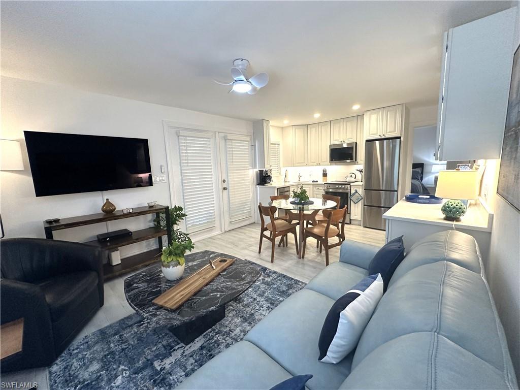 175 5th Avenue South, Unit 103 Naples, FL 34102 - Photo 5 of 18 a living room with furniture and a flat screen tv