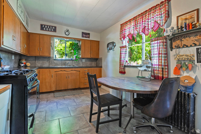 178 17th Street Ogden, UT 84404 - Photo 13 of 29 Kitchen featuring wood cabinetry, a built-in sink, and tile flooring