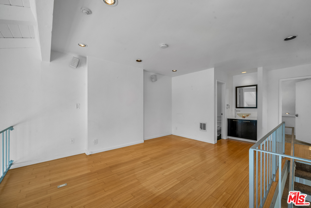 615 Esplanade, Unit 401 Redondo Beach, CA 90277 - Photo 12 of 19 a bedroom with a bed and a flat screen tv