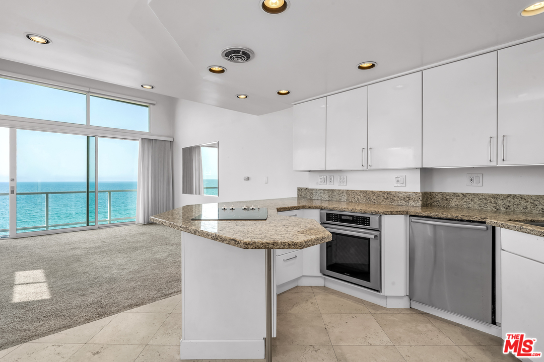 615 Esplanade, Unit 401 Redondo Beach, CA 90277 - Photo 7 of 19 a kitchen with a stove sink and cabinets