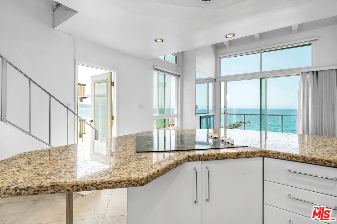 615 Esplanade, Unit 401 Redondo Beach, CA 90277 - Photo 8 of 19 a kitchen with granite countertop a sink and a window