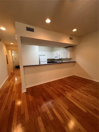 a view of a room with wooden floor