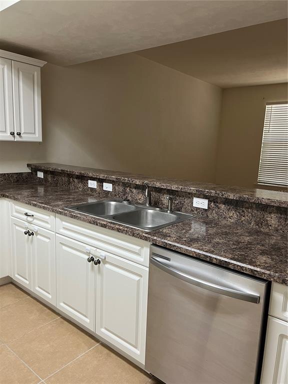 1569 Northwest 29 Road, Unit 3 Gainesville, FL 32605 - Photo 5 of 14 a kitchen with granite countertop a sink and cabinets