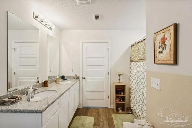 a bathroom with a double vanity sink and a mirror
