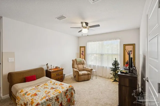 a bedroom with two beds and a chandelier