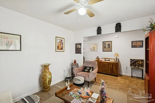 a living room with furniture and wooden floor
