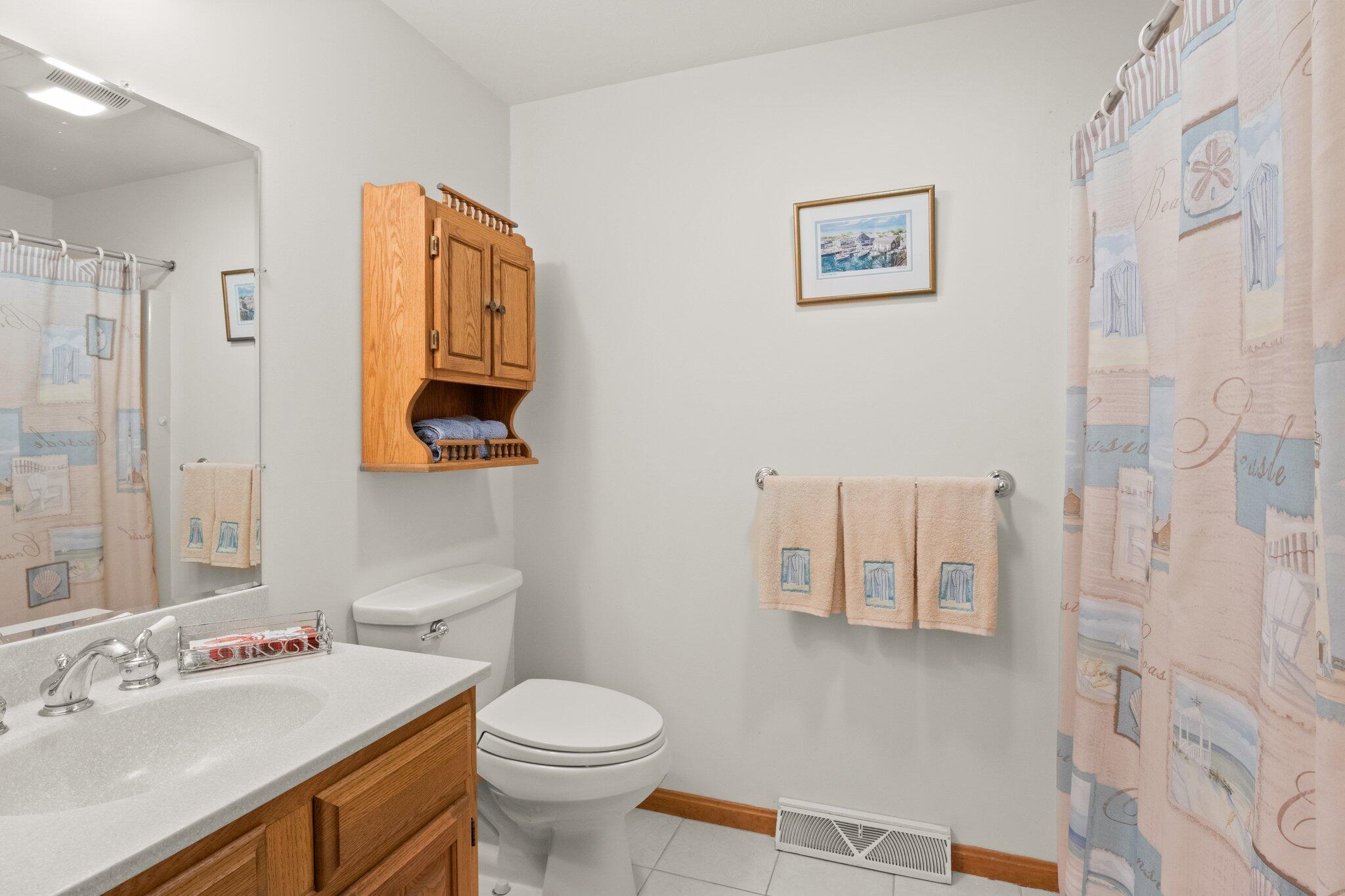 196 Eisenhower Drive Cotuit, MA 02635 - Photo 24 of 33 a bathroom with a sink mirror vanity and toilet