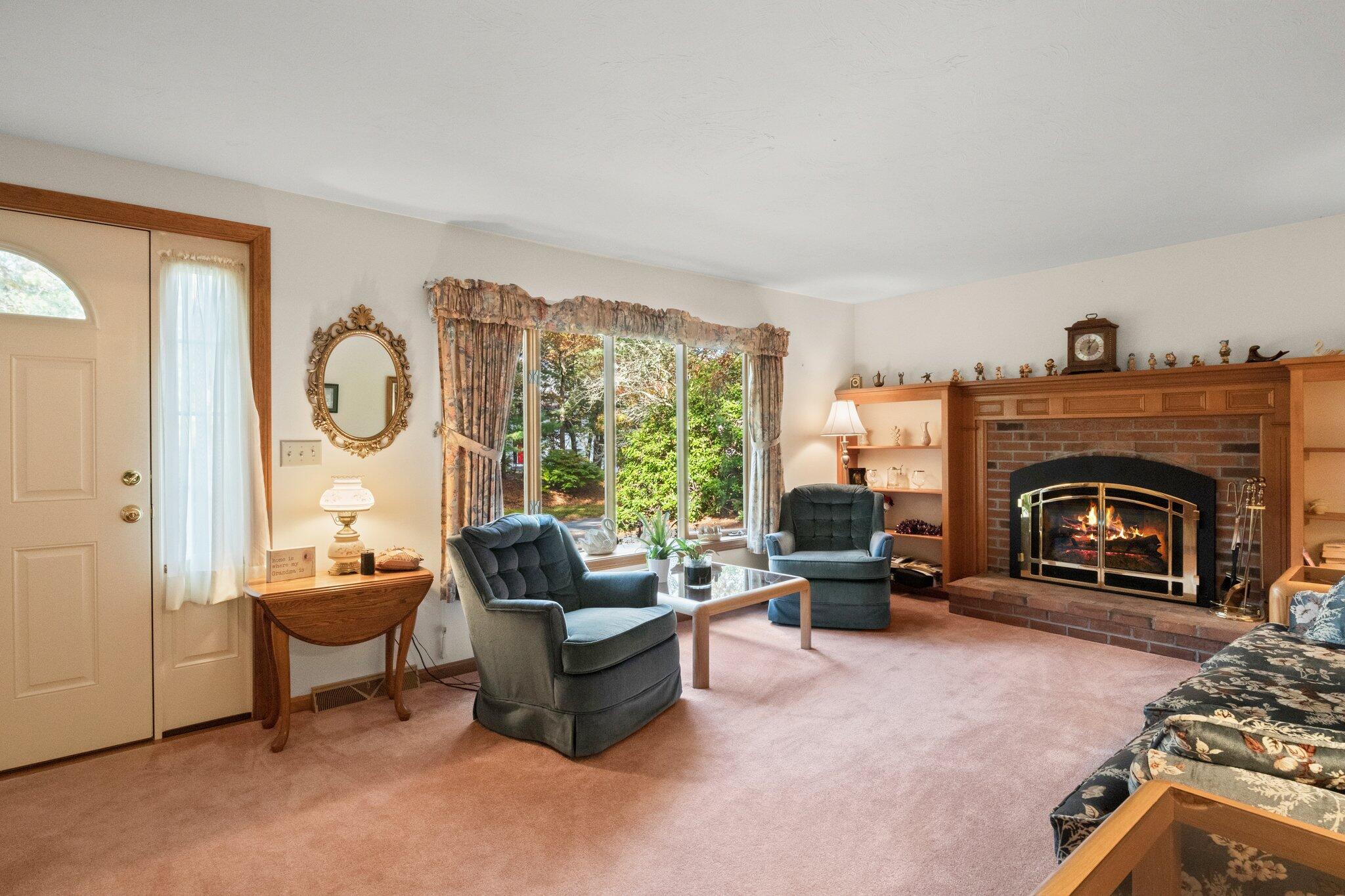 196 Eisenhower Drive Cotuit, MA 02635 - Photo 6 of 33 a living room with furniture and a fireplace