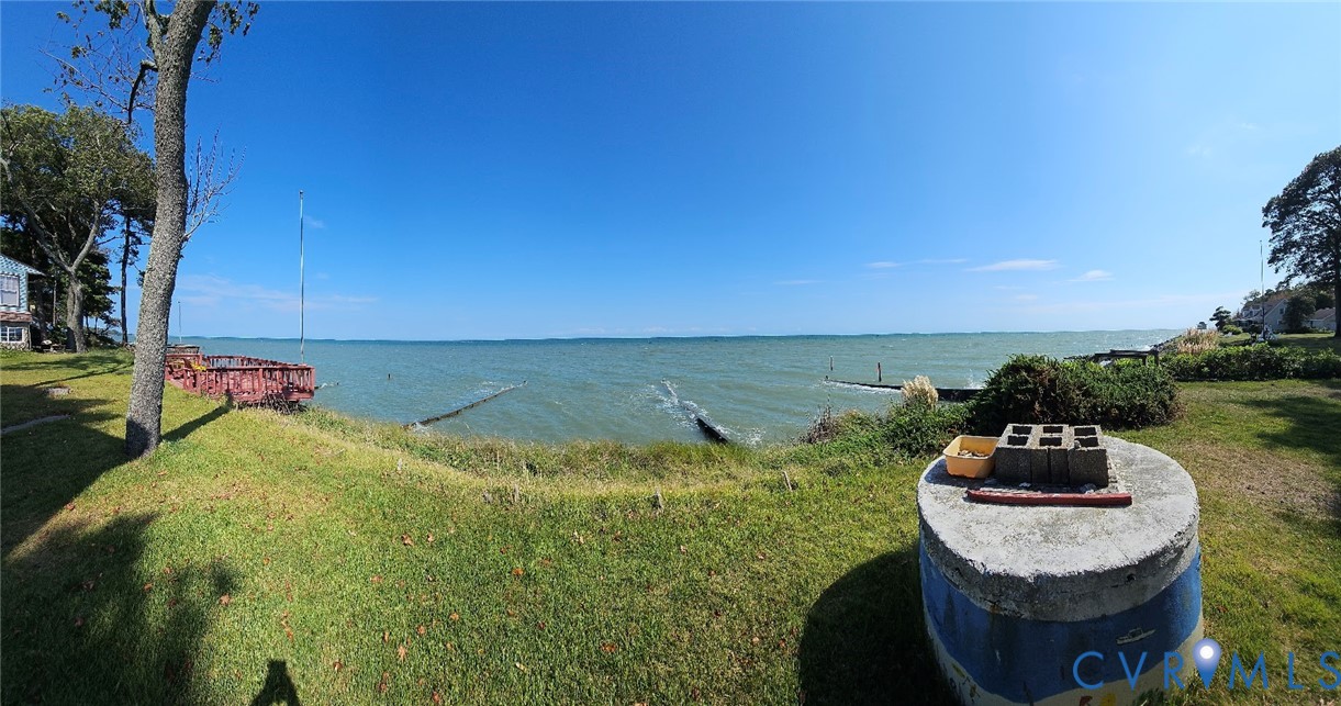 Waterfront property featuring expansive grassy are