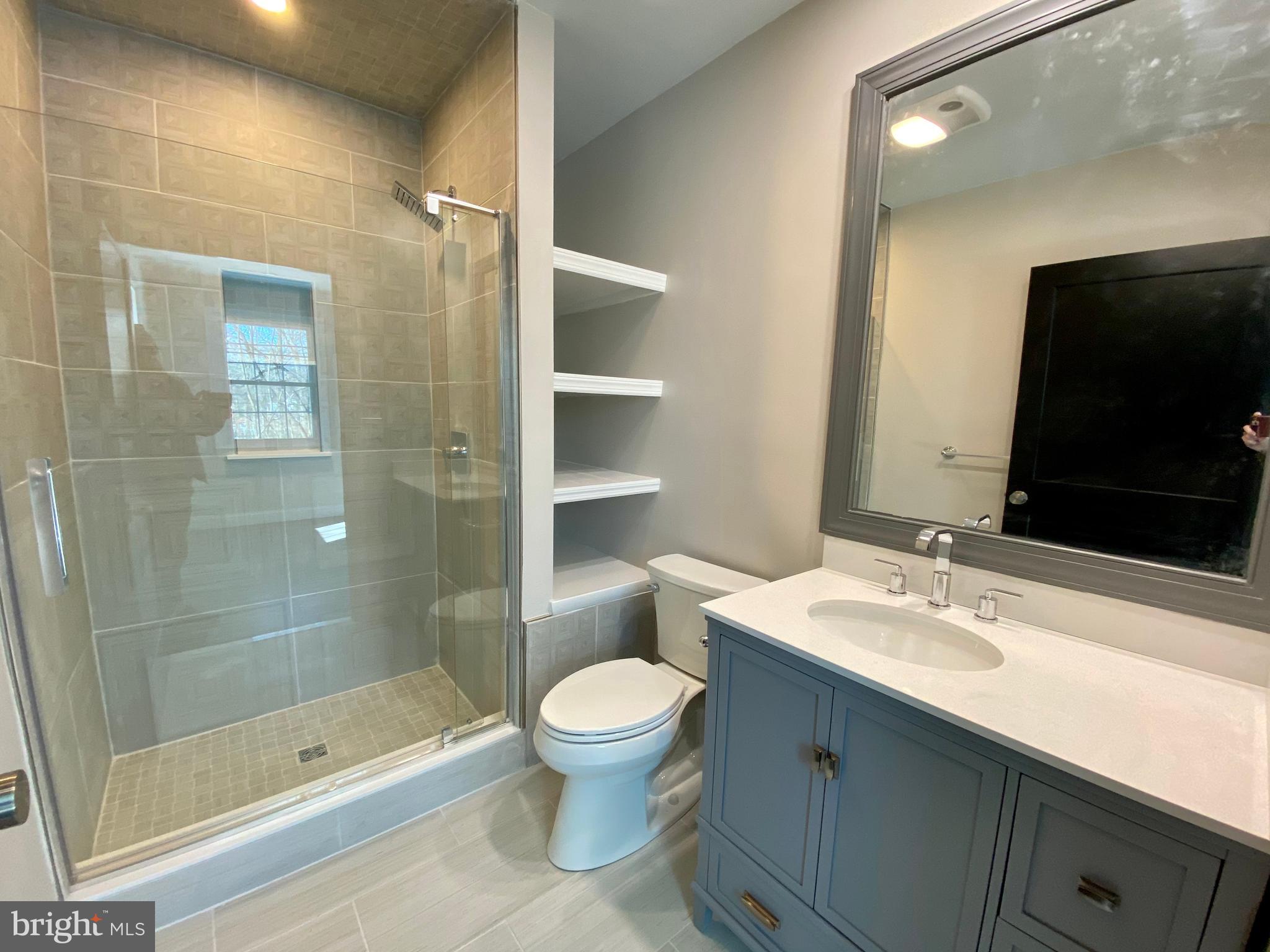 2417 Shellpot Drive Wilmington, DE 19803 - Photo 16 of 18 a bathroom with a sink a toilet and shower