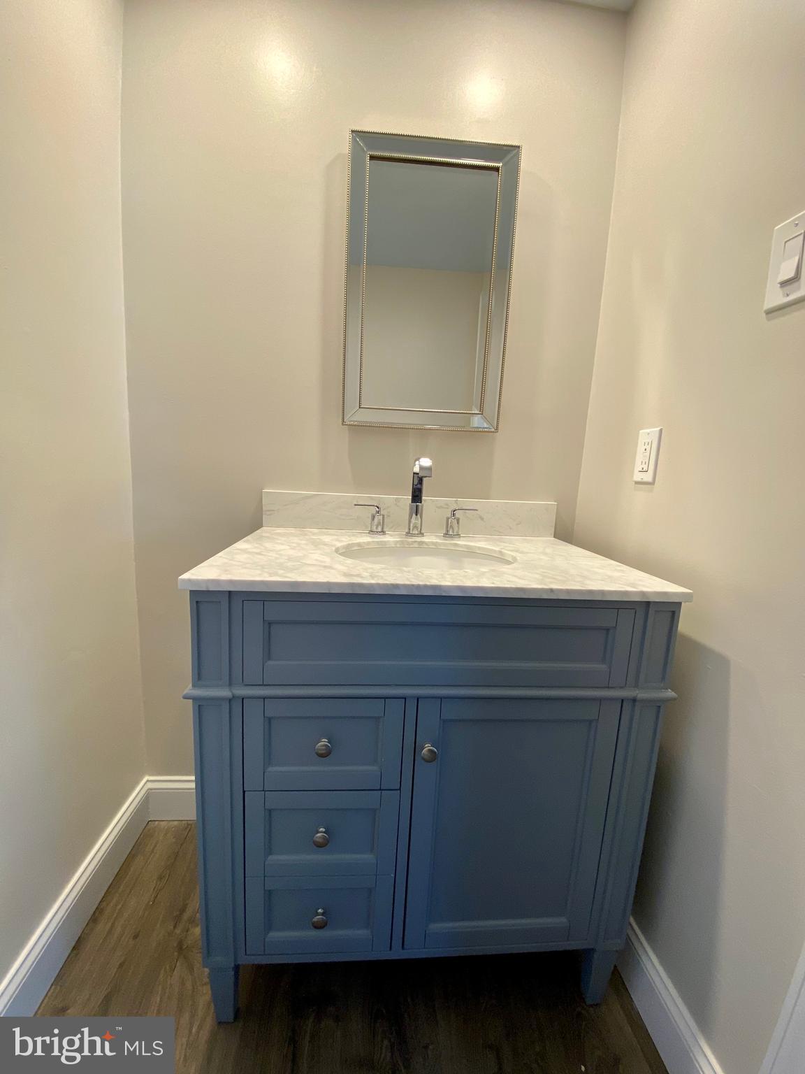 2417 Shellpot Drive Wilmington, DE 19803 - Photo 18 of 18 a bathroom with a sink and a mirror