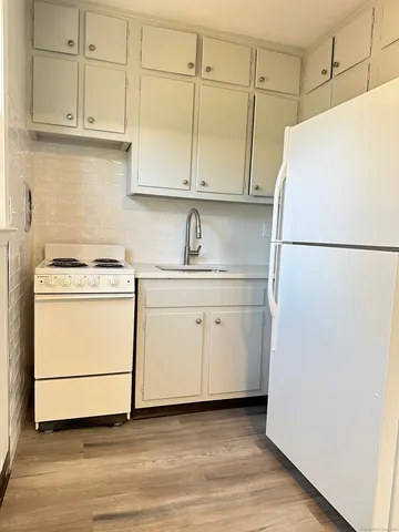 a white refrigerator freezer sitting inside of a kitchen