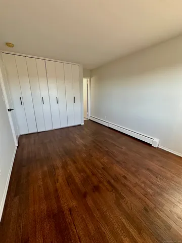 a view of an empty room and wooden floor