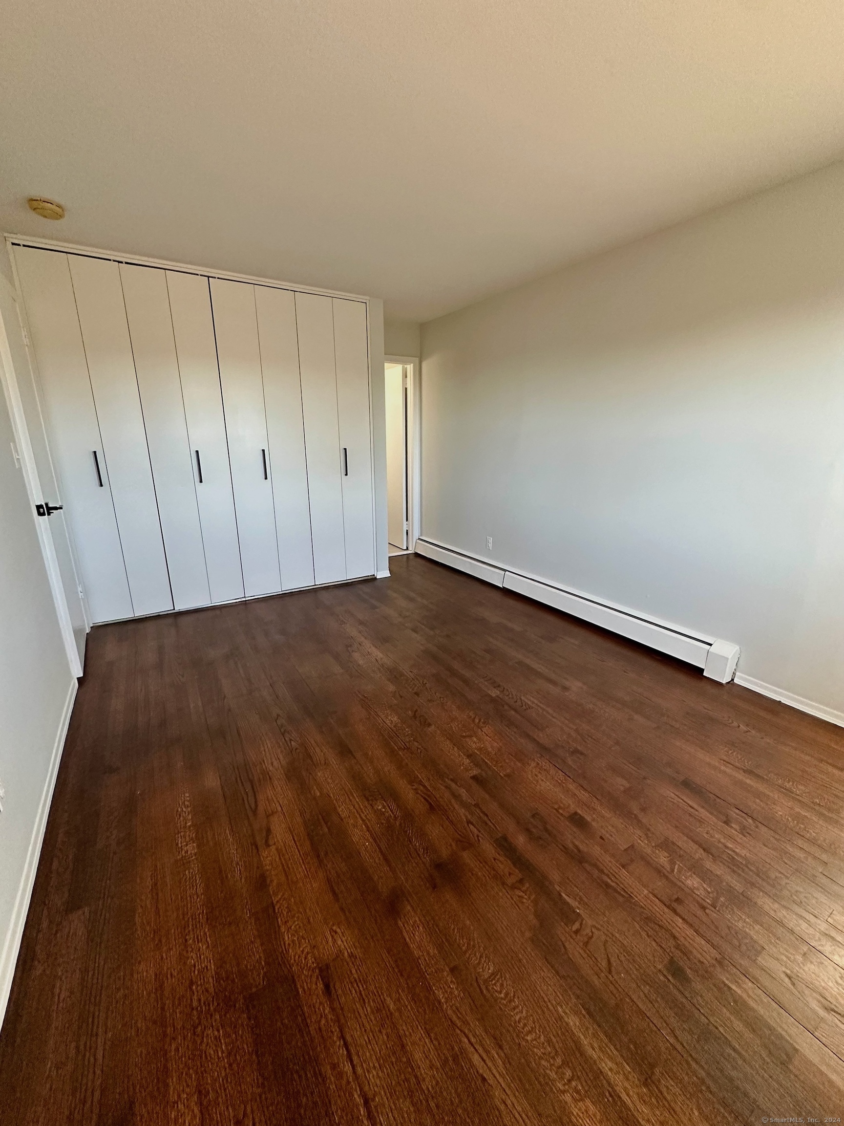 15 Pilgrim Trail, Unit B6 Woodbury, CT 06798 - Photo 5 of 7 a view of an empty room and wooden floor