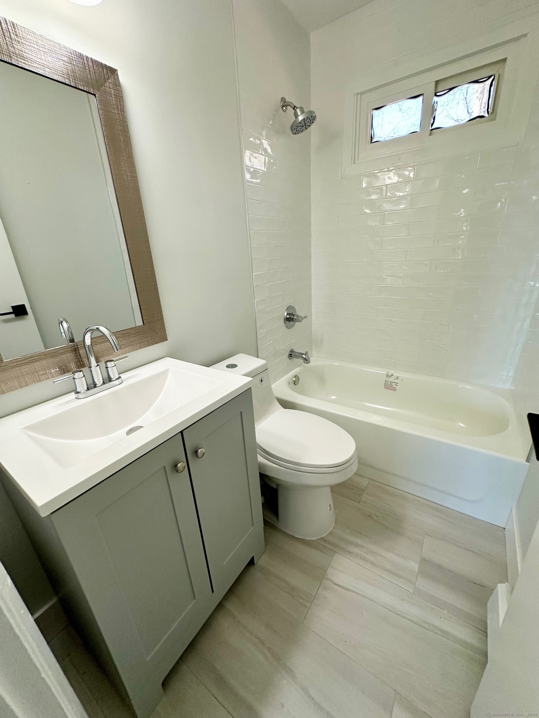 15 Pilgrim Trail, Unit B6 Woodbury, CT 06798 - Photo 6 of 7 a bathroom with a sink toilet a mirror and shower
