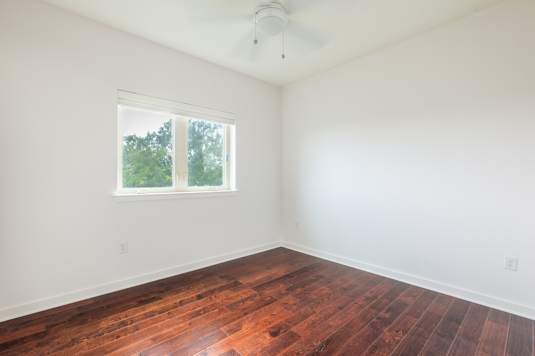6700 Menchaca Road, Unit 24 Austin, TX 78745 - Photo 11 of 18 Unfurnished room with dark wood-style flooring and a ceiling fan