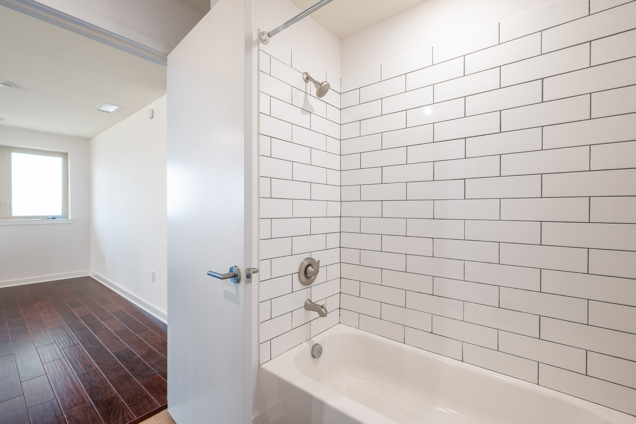 6700 Menchaca Road, Unit 24 Austin, TX 78745 - Photo 12 of 18 Full bathroom featuring shower / bath combination and dark wood-type flooring